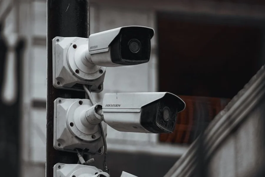AI camera monitoring parking spaces Security camera mounted on urban infrastructure monitoring street parking availability