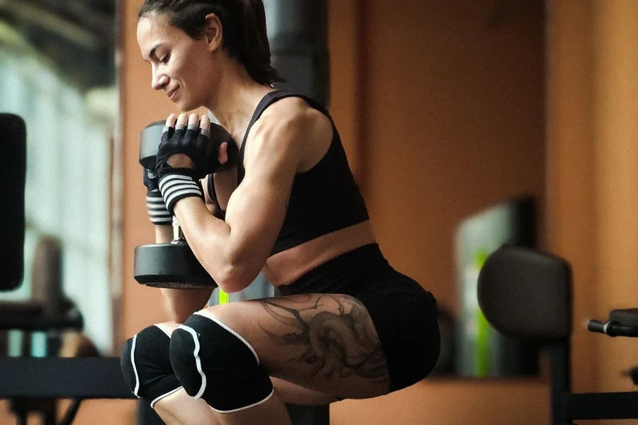 Exercise Form Check Person performing a squat with dumbbells during an exercise form check