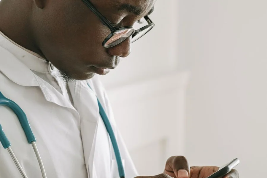 Appointment Reminder Text Patient looking at a dental appointment reminder text message on a smartphone