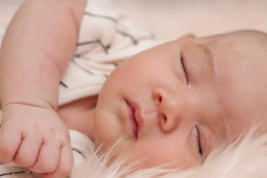 Safe Sleep Setup Infant sleeping on their back in an empty crib following safe sleep guidance
