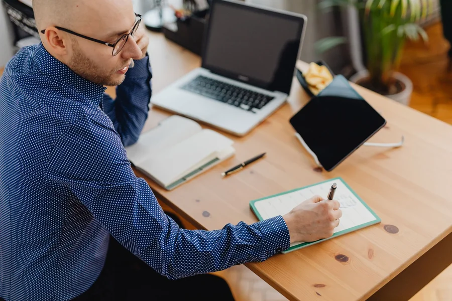Manager Planning Cover Manager at an office desk reviewing work after receiving an absence notice