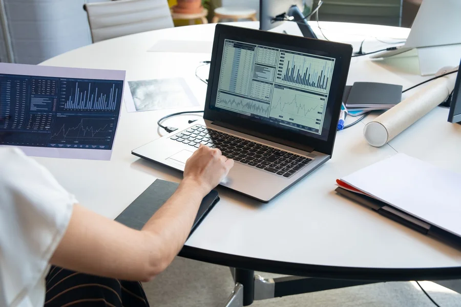 Reading PC Health Data Person reviewing laptop performance and computer diagnostics readings on a screen at a desk