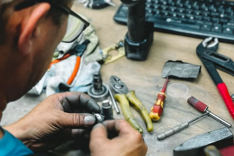 Appliance repair technician using diagnostic tools to troubleshoot a refrigerator issue