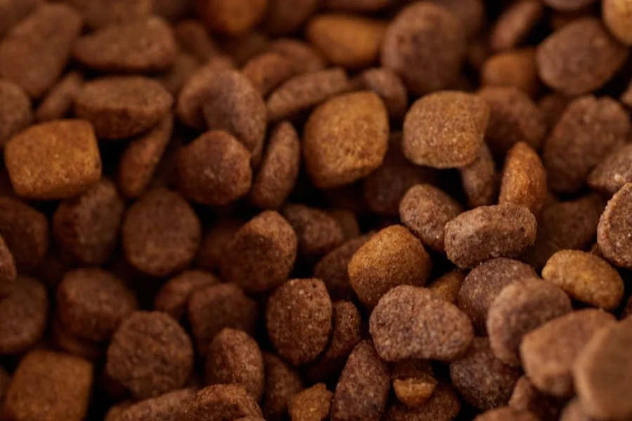 Dry cat kibble close up Close up of brown dry kibble pieces from a barn cat dry cat food 32lb bag