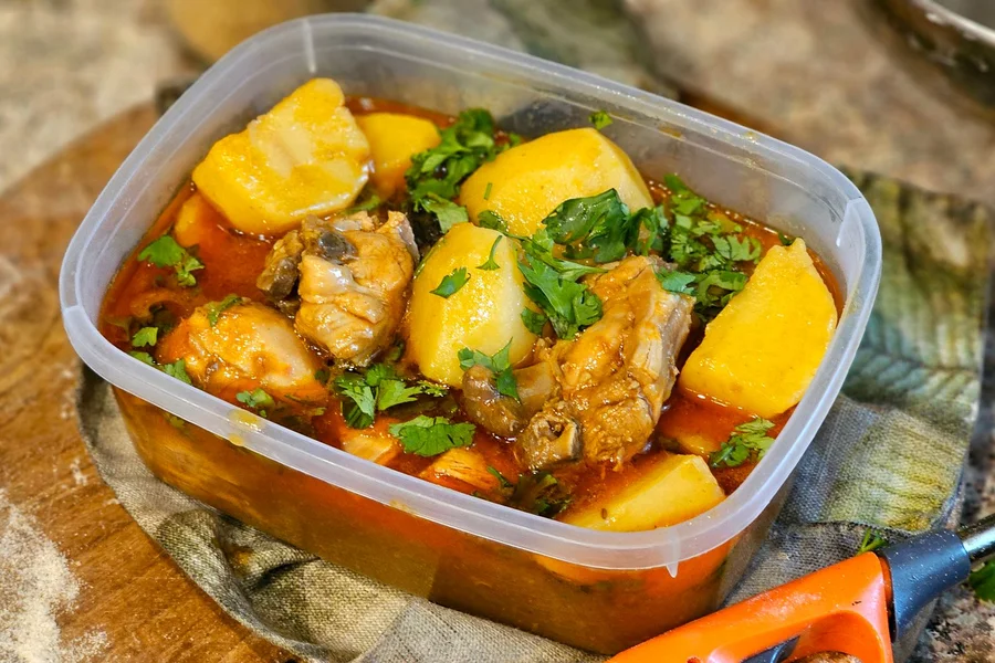 Freezing Single Portions Portioning cooked soup into single serving freezer containers in a home kitchen