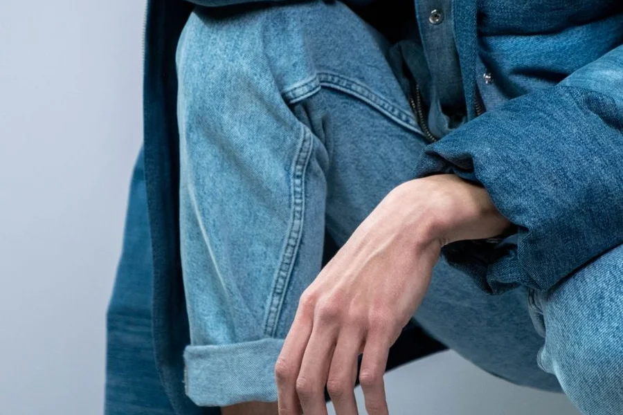 Close up of a rolled denim hem showing a neat double cuff fold detail