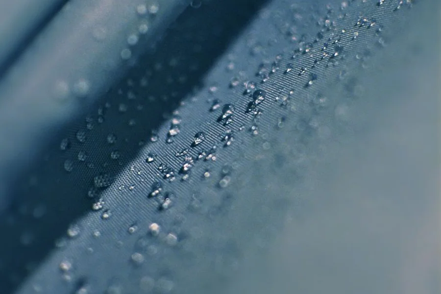Water droplets beading on the surface of a jacket fabric